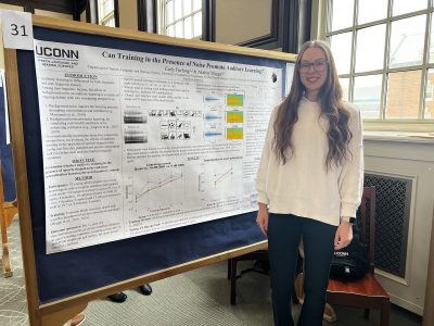 Photo of Carly in front of poster